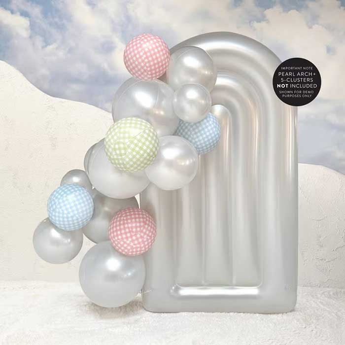 reusable gingham balloons added to a balloon arch of silver balloons against a backdrop of a silver inflatable arch