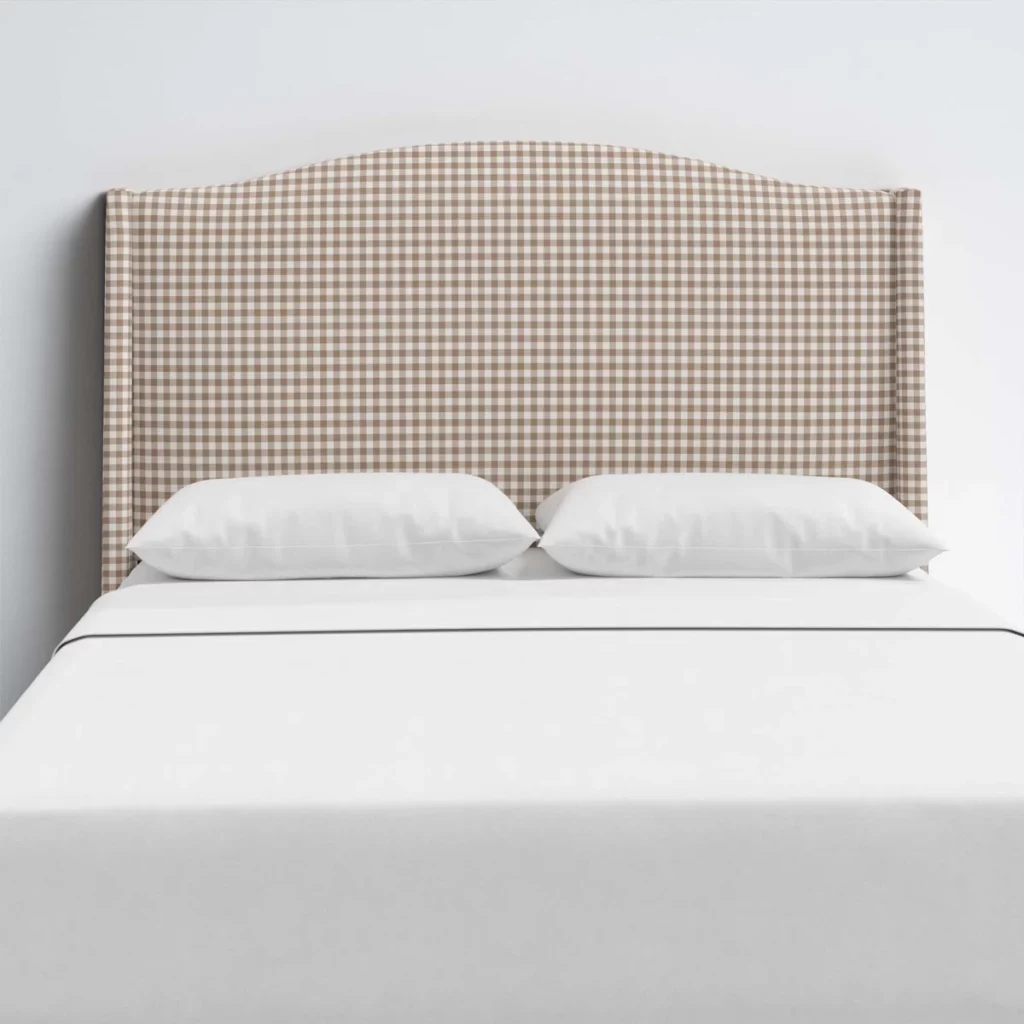 tan gingham headboard with white pillows and sheets