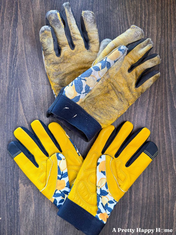 two pairs of bright yellow leather work gloves with a contrasting lemon fabric print. One of the sets of gloves is completely worn out. The other is brand new.