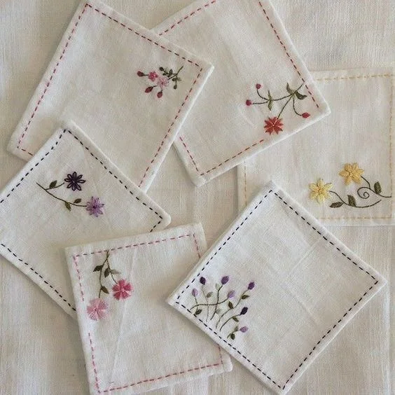 diy embroidered white handkerchief with simple stitched borders and flowers in the corner from tiana's closet