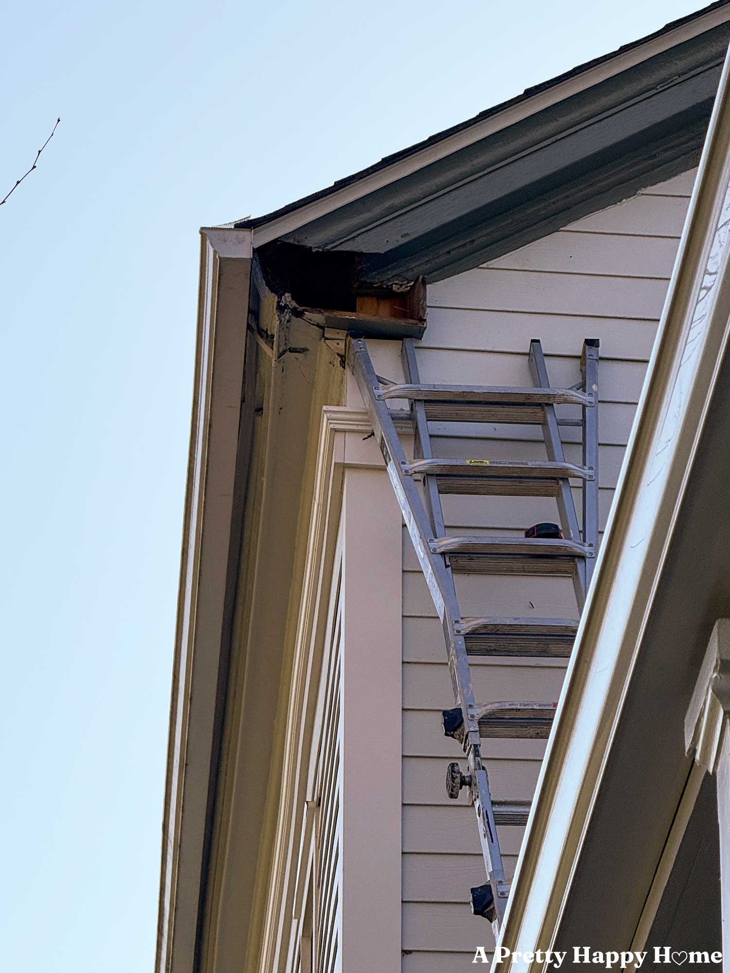 close up view of a gable return repair in process. the rotting gable return has been removed exposing a hole in the house.