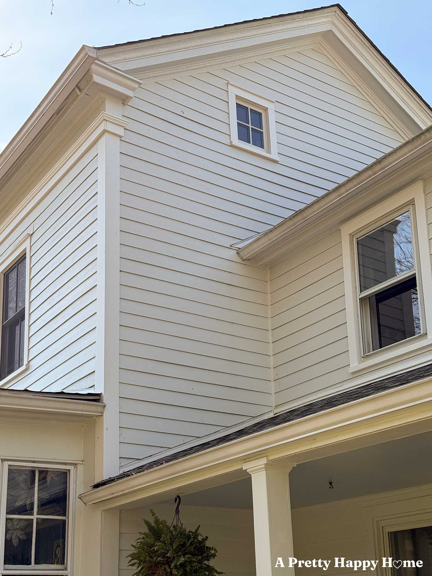 Repaired gable return on a greek revival home that is painted white.