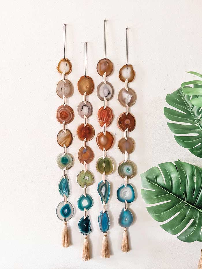 4 colorful garlands hanging vertically and made of agate slices in red and blue tones