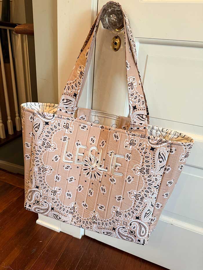 handmade bandana tote bag made out of bandanas in a light tan color and embroidered with the name Leslie