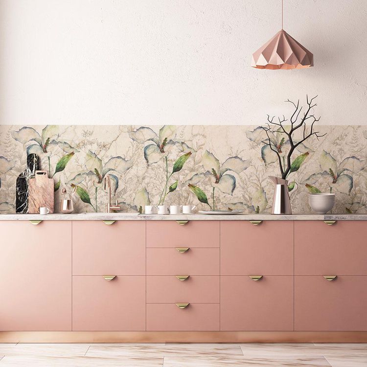 mural wallpaper installed as a backsplash above a bank of pink cabinets