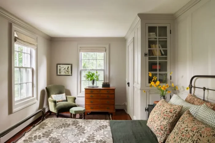 bedroom in an 18th century farmhouse tastefully restored featuring a closet with a glass paneled cabinet on the end