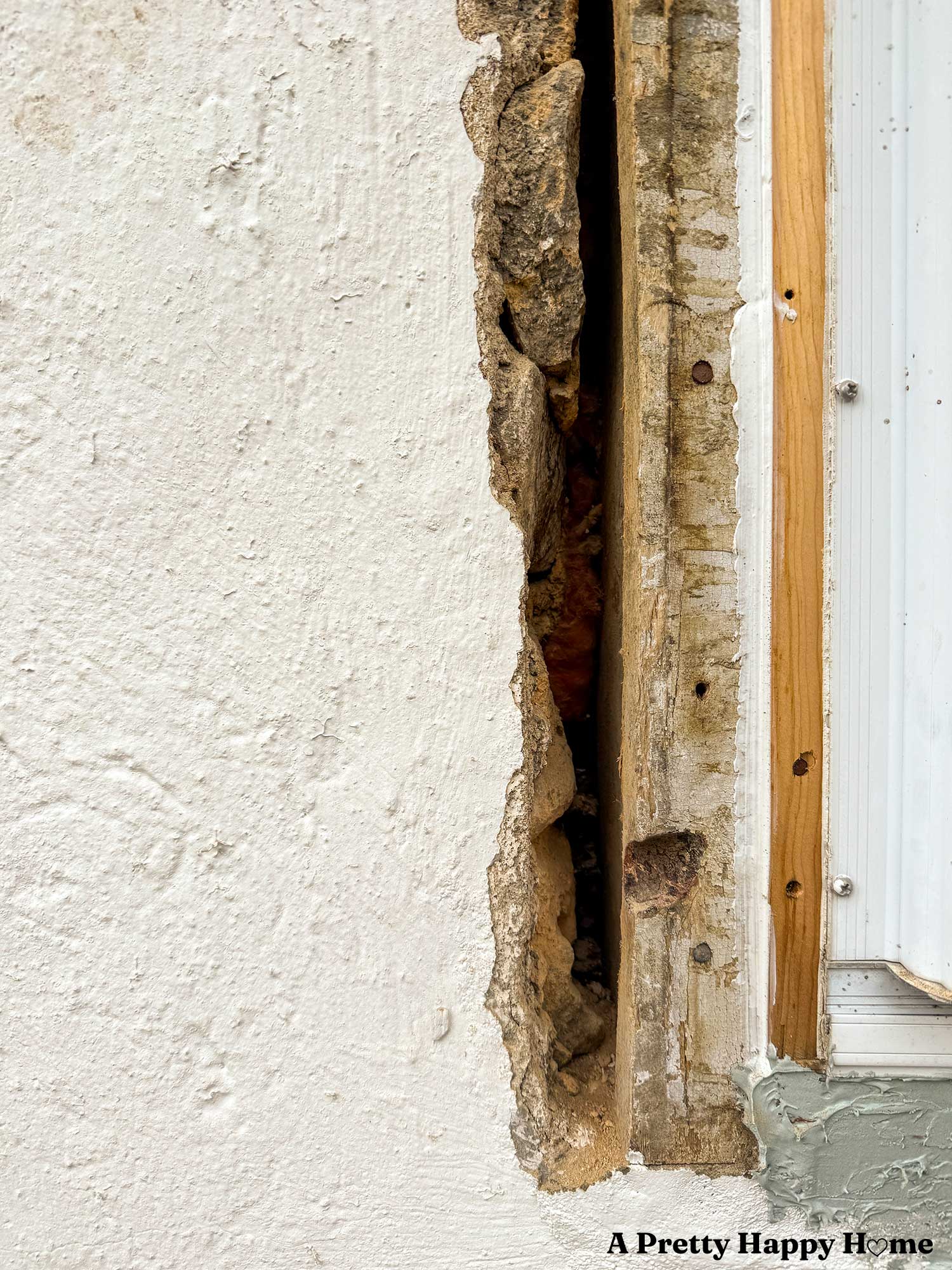 filling a gap with lime mortar on a stone building next to a window