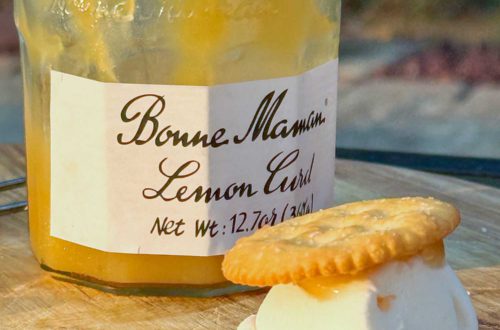 jar of bonne maman lemon curd with a lemon curd s'mores made with ritz crackers and marshmallow in front of it