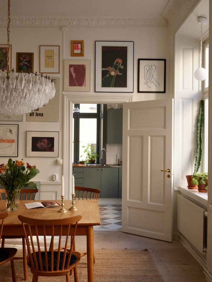 gallery wall hung over a door in an ornately appointed period home's dining room
