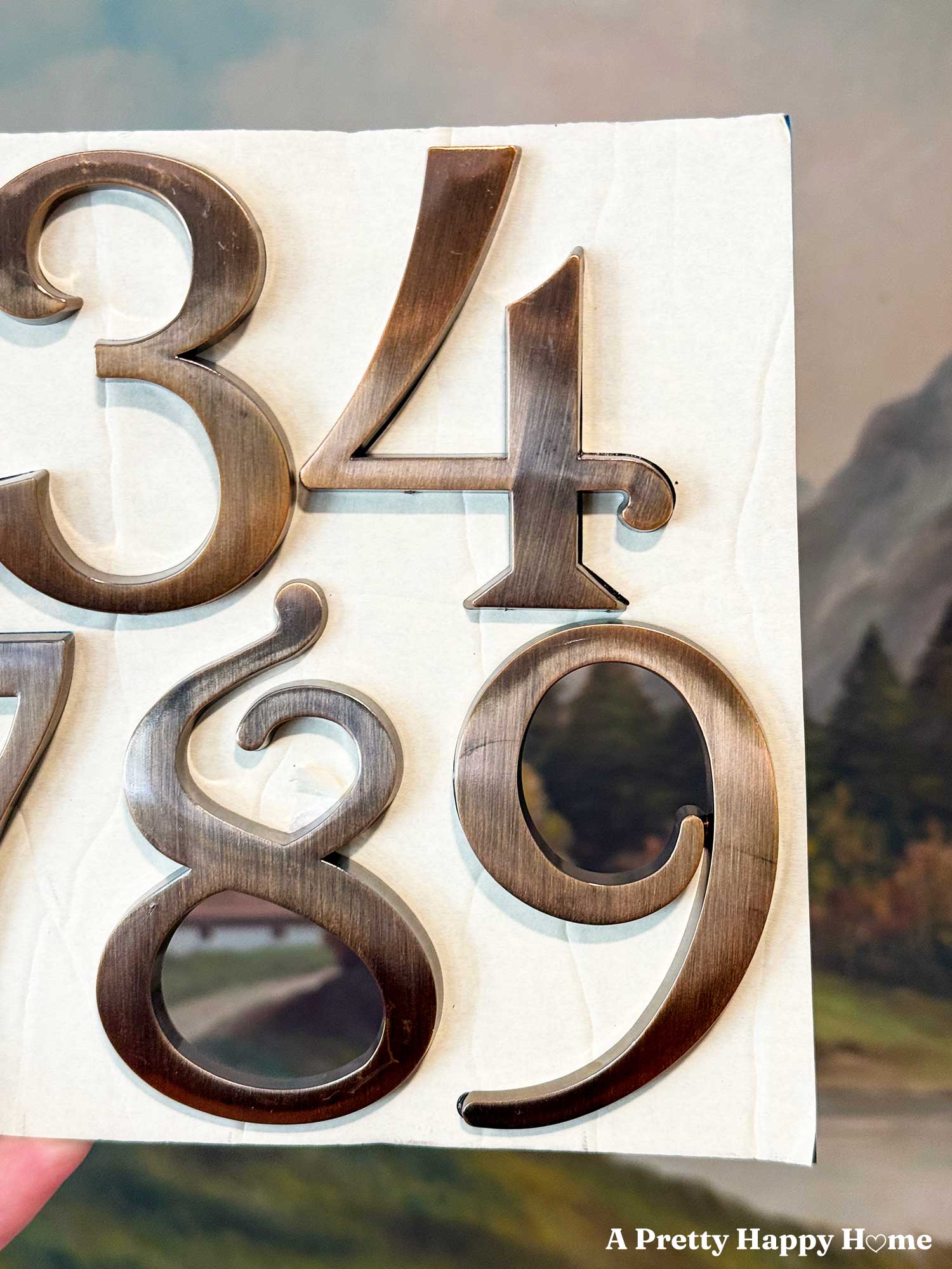 classy 3-d mailbox numbers 3, 4, 8, and 9 on a sheet of paper in a bronze color