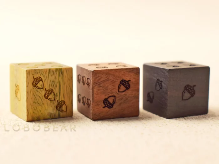 set of three wood dice with acorns for the dots