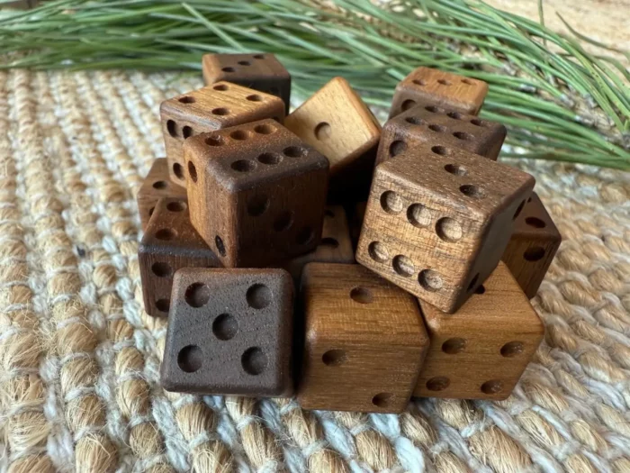 walnut wood dice heaped in a pile