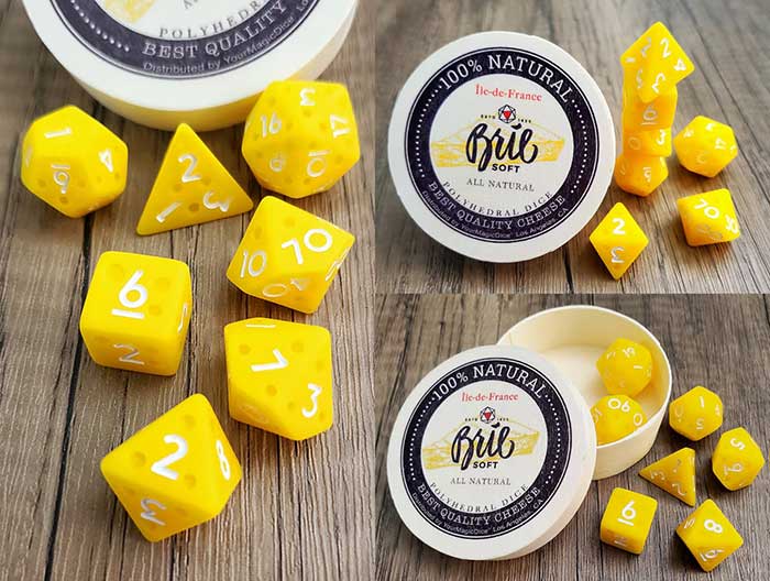 set of dice made to look like cheese that come in a box labeled brie