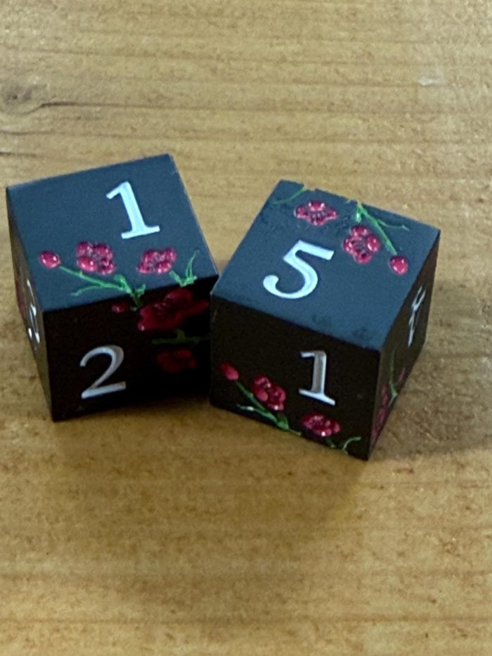 metal mahjong dice set colored black with pink flowers and white numbers